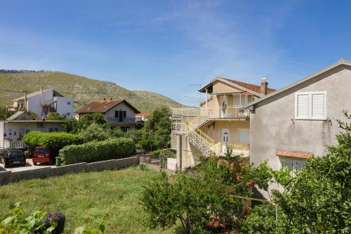a group of houses with a hill in the background at Apartments by the sea Grebastica, Sibenik - 4881 in Bašelovići