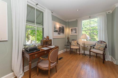 an office with a desk and chairs and windows at The Old Bank House in Niagara on the Lake