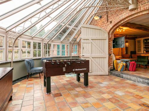 a pool table in a conservatory with a glass ceiling at Alverwege 2 in Baerle Heide