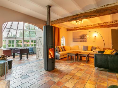 a living room with a fireplace in the middle at Alverwege 2 in Baerle Heide