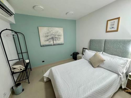 a bedroom with a bed and a painting on the wall at EasyHouse in Medellín