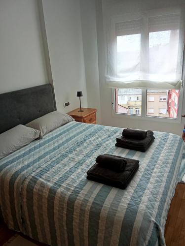 a bedroom with a bed with two towels on it at San Marcos in Ribadeo