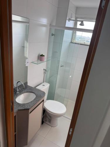 a bathroom with a toilet and a glass shower at Belíssimo Apto a 2 km da Litorânea in São Luís