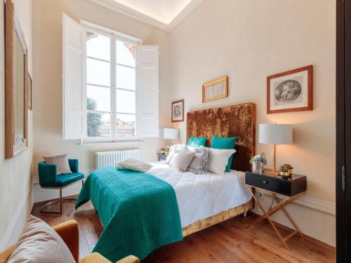 a bedroom with a bed and a window at Apartment in Lucca near Guinigi Tower in Lucca