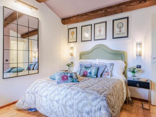 a bedroom with a bed and a mirror at Villa in Pescia with Tuscan Wine Views in Pescia