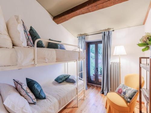 a bedroom with two bunk beds and a desk at Villa in Pescia with Tuscan Wine Views in Pescia