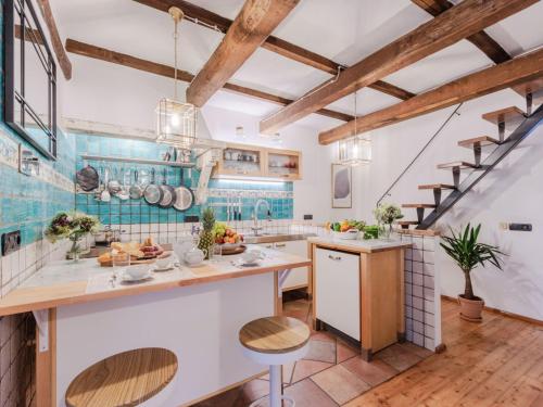 a kitchen with wooden ceilings and blue tiles at Villa in Pescia with Tuscan Wine Views in Pescia