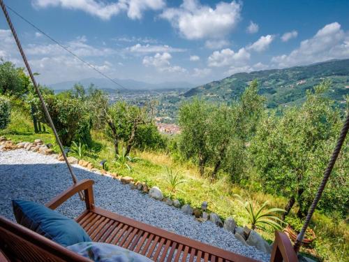 a hammock with a view of a mountain at Villa in Pescia with Tuscan Wine Views in Pescia