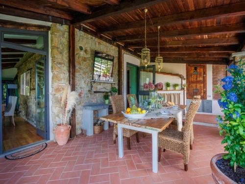 a dining room with a table and chairs on a patio at Villa in Pescia with Tuscan Wine Views in Pescia