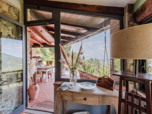 a room with a table and a large window at Villa in Pescia with Tuscan Wine Views in Pescia