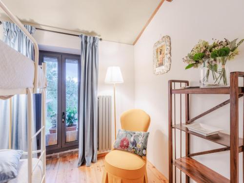 a room with a chair and a window at Villa in Pescia with Tuscan Wine Views in Pescia