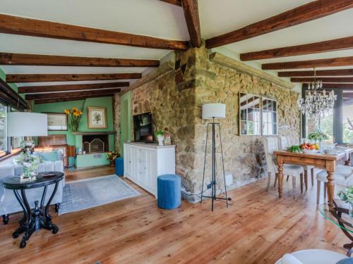 a living room with wooden floors and a stone wall at Villa in Pescia with Tuscan Wine Views in Pescia