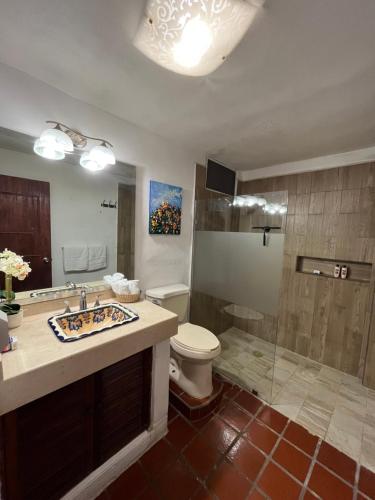 a bathroom with a toilet and a sink and a shower at Departamento en Marina Vallarta New listing in Puerto Vallarta