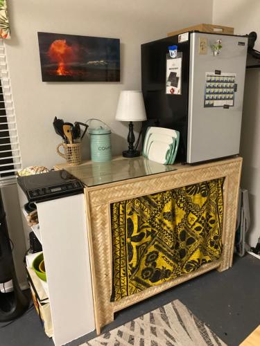 a kitchen with a counter and a refrigerator at Comfort Nest in Pahoa