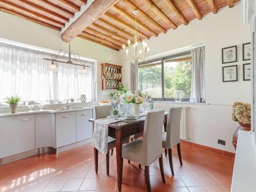a dining room with a table and chairs and a kitchen at Farmhouse near Lucca with Tuscan Views in Pieve di compito