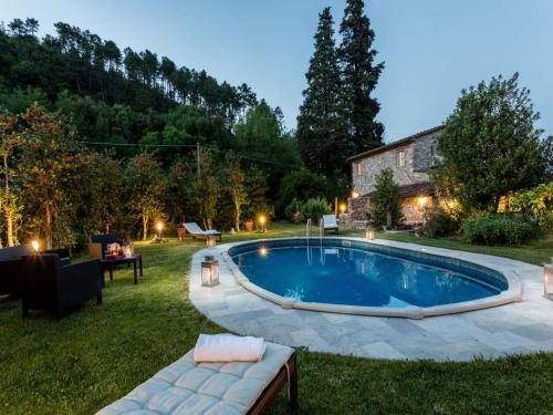 a swimming pool in the yard of a house at Farmhouse near Lucca with Tuscan Views in Pieve di compito