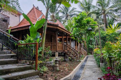 a house in the middle of a garden at Sweet Orange Pondok in Ubud