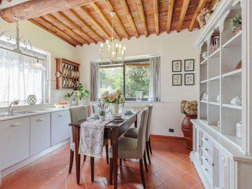 a kitchen with a table and chairs and a dining room at Farmhouse near Lucca with Tuscan Views in Pieve di compito