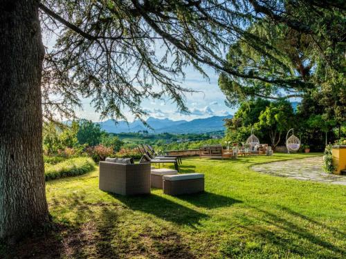 a park with two couches sitting in the grass at 10 Bedrooms Villa in Lucca with pool in Montecarlo