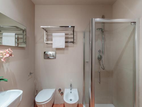 a bathroom with a shower and a toilet and a sink at 10 Bedrooms Villa in Lucca with pool in Montecarlo