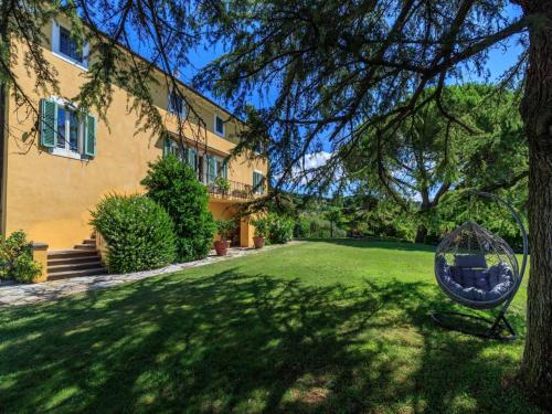 a house with a yard with a swing at 10 Bedrooms Villa in Lucca with pool in Montecarlo