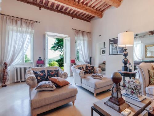 a living room with two couches and a table at 10 Bedrooms Villa in Lucca with pool in Montecarlo