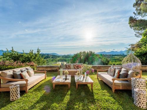 a garden with two couches and a table at 10 Bedrooms Villa in Lucca with pool in Montecarlo
