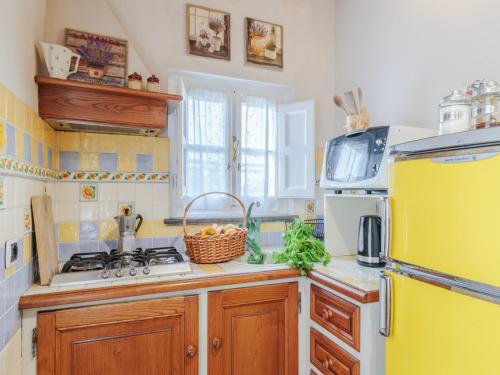 a kitchen with a yellow refrigerator and a sink at Farmhouse in Tuscany with Pool and Scenic Views in Chiatri