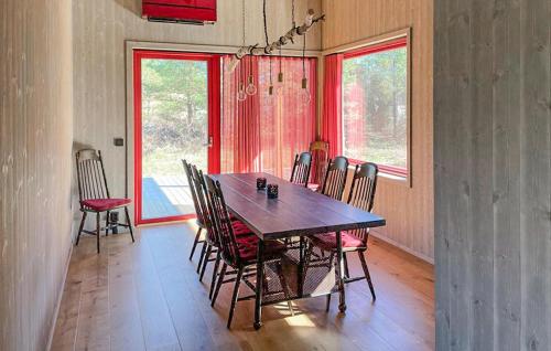 a dining room with a wooden table and chairs at 2 Bedroom Cozy Home In Lärbro in Lärbro