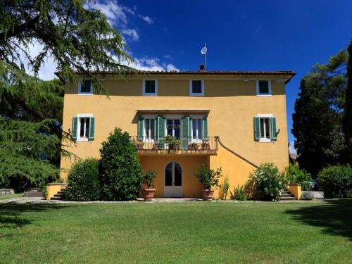 a large yellow house with a large yard at 10 Bedrooms Villa in Lucca with pool in Montecarlo
