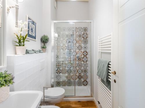 a bathroom with a toilet and a glass shower at Apartment in Montecarlo near Wine Region in Montecarlo