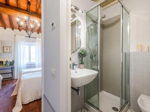 a bathroom with a glass shower and a sink at Apartment in Montecarlo near Wine Region in Montecarlo