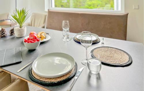 a table with plates and glasses and a bowl of fruit at Awesome Home In Lautenthal With Sauna in Lautenthal