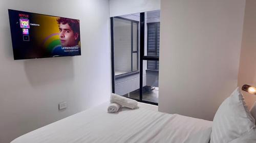 Ένα ή περισσότερα κρεβάτια σε δωμάτιο στο Unicentro Apartamentos, WiFi y Parking Gratis