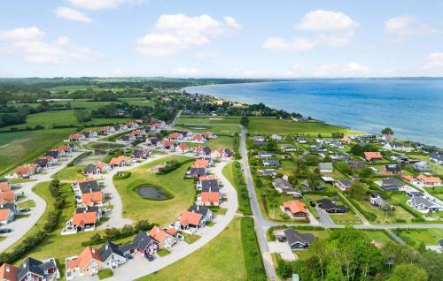 an aerial view of a village next to the ocean at Holiday Home Strandgårdsvej V in Bro