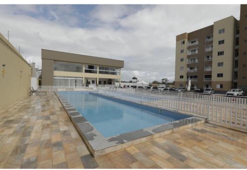 a large swimming pool in front of a building at Belíssimo Apto a 2 km da Litorânea in São Luís