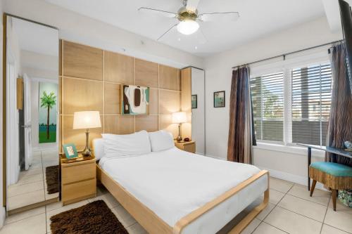 a bedroom with a large bed and a window at 30A - Cassine Station by Panhandle Getaways in Santa Rosa Beach