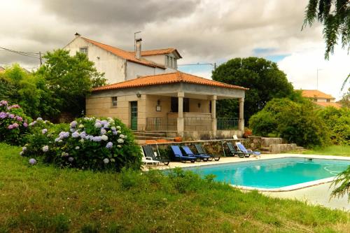 a house with a swimming pool in front of it at Rustic Terrace2 Bedrooms Farm House in Mesquitela