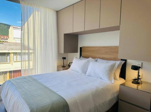 Ένα ή περισσότερα κρεβάτια σε δωμάτιο στο Unicentro Apartamentos, WiFi y Parking Gratis