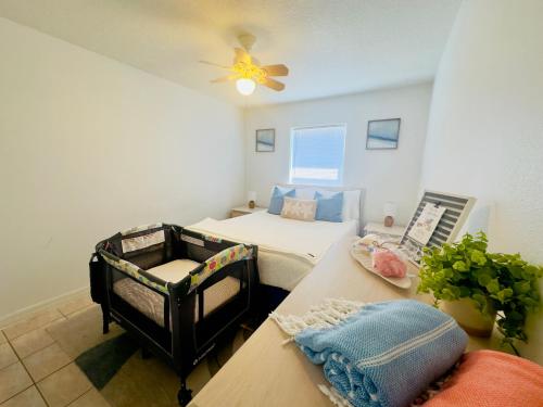a bedroom with a bed and a ceiling fan at Steps to the Sand - Private Beach Access & BBQ Grill in Indialantic