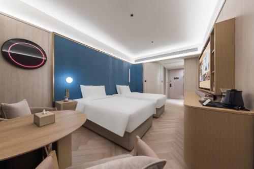 Voodi või voodid majutusasutuse Tianjin Station Crystal Orange Hotel toas