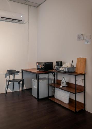 a room with two desks and a chair and a table at Aayu Chowrasta - 3 mins walk to Penang Road Chendul in George Town