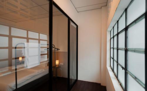 a room with a mirror and a bed and a window at Aayu Chowrasta - 3 mins walk to Penang Road Chendul in George Town