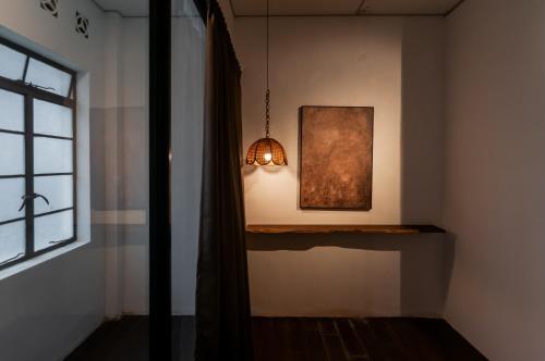 a room with a lamp and a picture on the wall at Aayu Chowrasta - 3 mins walk to Penang Road Chendul in George Town