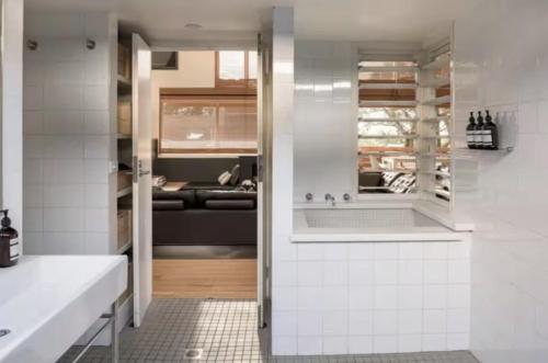 a bathroom with a sink and a bath tub at One Hundred Banksias in Culburra Beach
