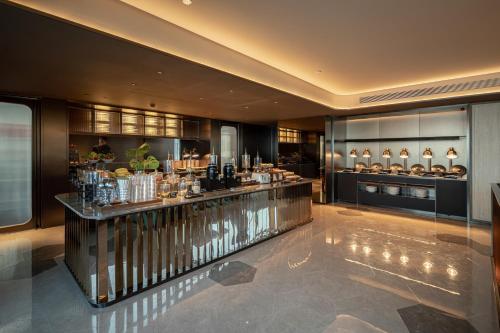 a lobby with a bar in a building at 成都高新电子科大桔子水晶酒店 in Chengdu