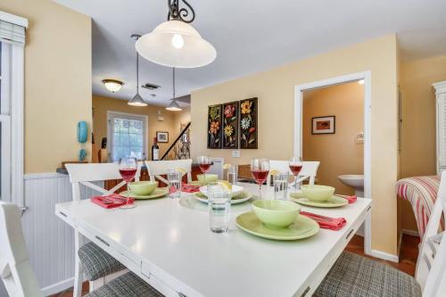 a dining room with a white table and chairs at Cottage by the Pool by AvantStay w Balcony BBQ Shared Pool Month Long Stays Only in Stock Island