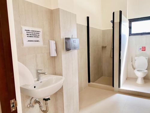 a bathroom with a sink and a toilet at Seaview Condo in Royal Oceancrest Panglao in Dauis