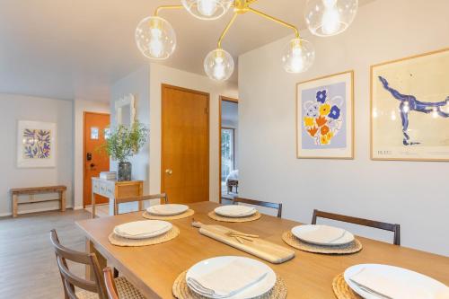 a dining room with a wooden table and chairs at Whidbey Bliss by AvantStay 2min to Beach View in Greenbank