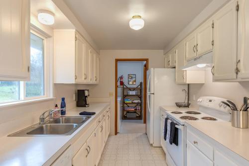 a kitchen with white cabinets and a sink at Whidbey Bliss by AvantStay 2min to Beach View in Greenbank